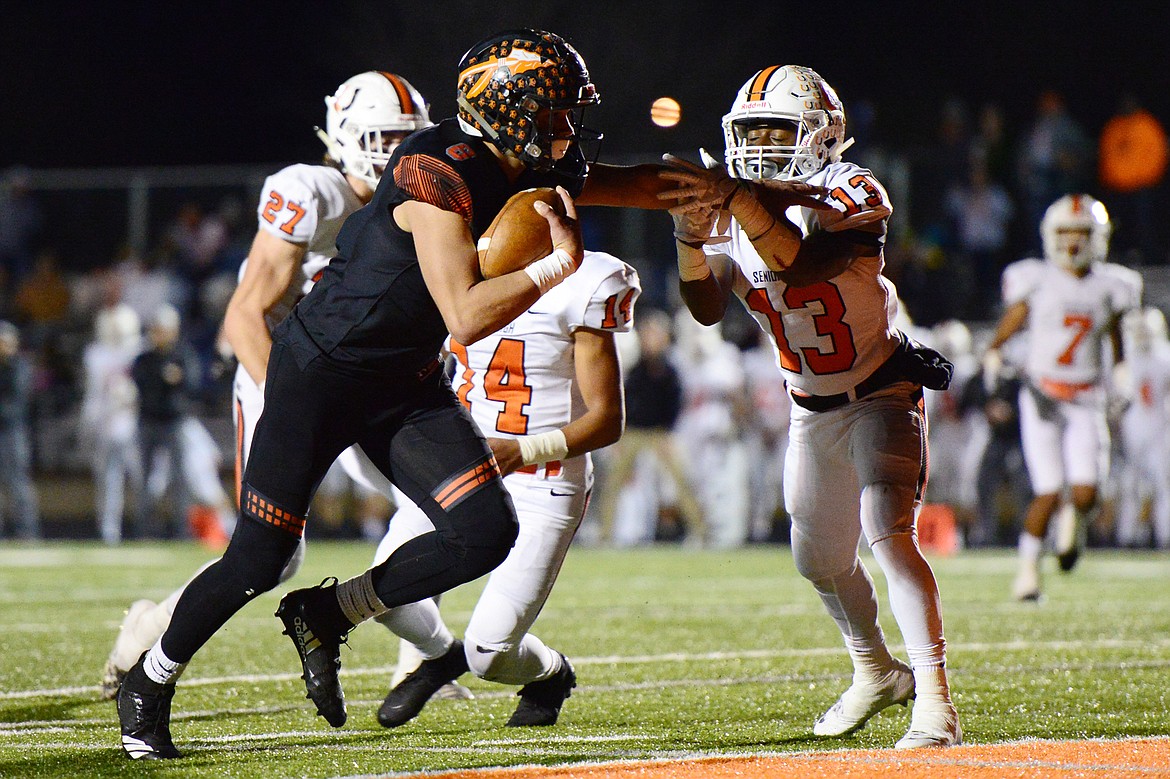 Flathead wide receiver Anthony Jones (8) fights his way into the end zone on a 24-yard touchdown reception in the second quarter against Billings Senior in a Class AA quarterfinal playoff game at Legends Stadium on Friday. (Casey Kreider/Daily Inter Lake)