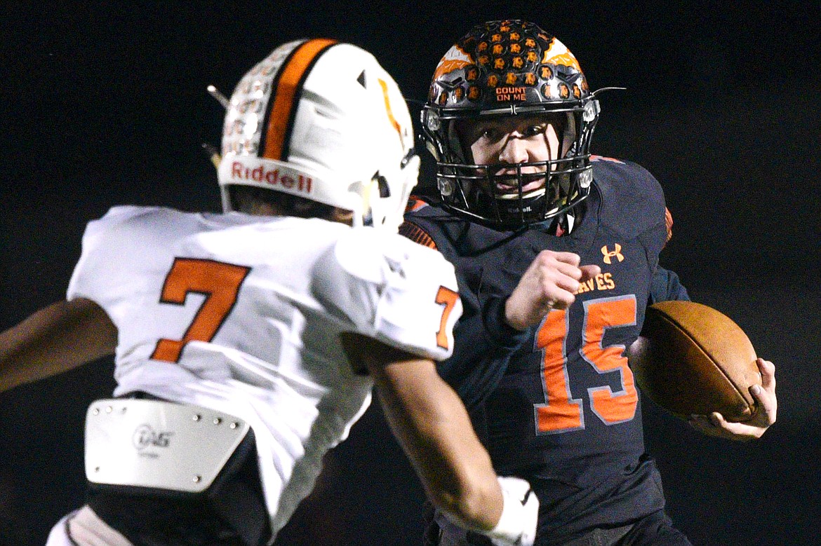 Flathead quarterback Jaden MacNeil (15) looks to get past Billings Senior defensive back Junior Bergen (7) on a first quarter run in a Class AA quarterfinal playoff game at Legends Stadium on Friday. (Casey Kreider/Daily Inter Lake)