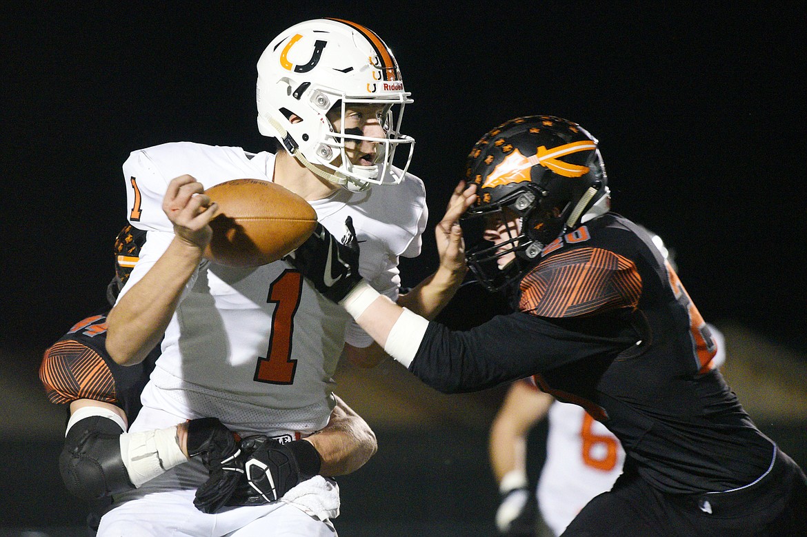 Billings Senior quarterback Matt Plasterer (1) fumbles as he's sacked by Flathead's Tanner Russell (44) and Gunnar Landrum (20) in the first quarter at Legends Stadium on Friday. Flathead recovered the fumble. (Casey Kreider/Daily Inter Lake)