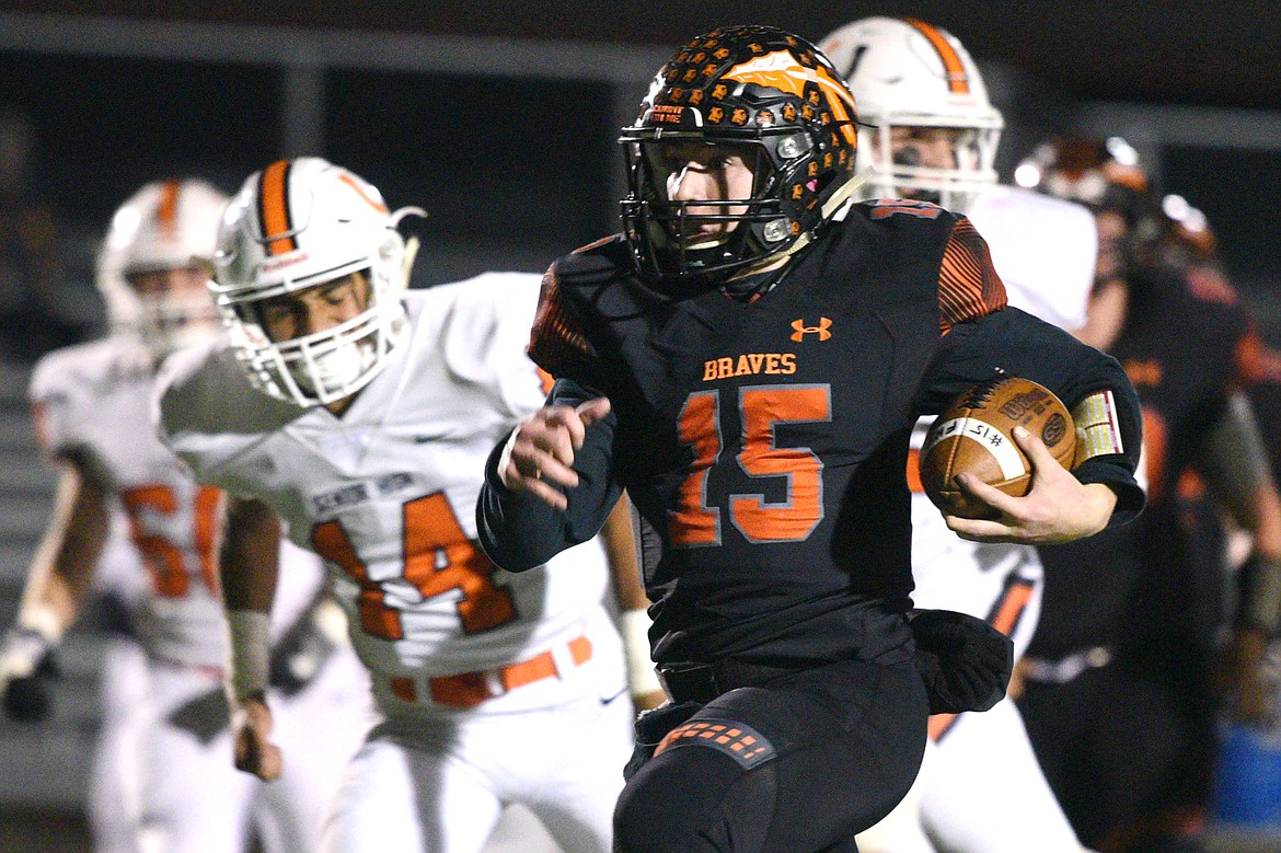 Flathead quarterback Jaden MacNeil (15) breaks free on a 28-yard touchdown run in the first quarter against Billings Senior in a Class AA quarterfinal playoff game at Legends Stadium on Friday. (Casey Kreider/Daily Inter Lake)