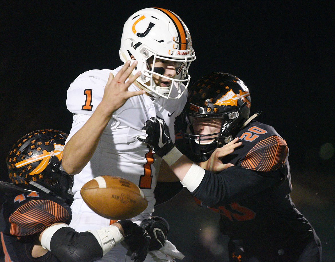 Billings Senior quarterback Matt Plasterer (1) fumbles as he's sacked by Flathead's Tanner Russell (44) and Gunnar Landrum (20) in the first quarter at Legends Stadium on Friday. Flathead recovered the fumble. (Casey Kreider/Daily Inter Lake)