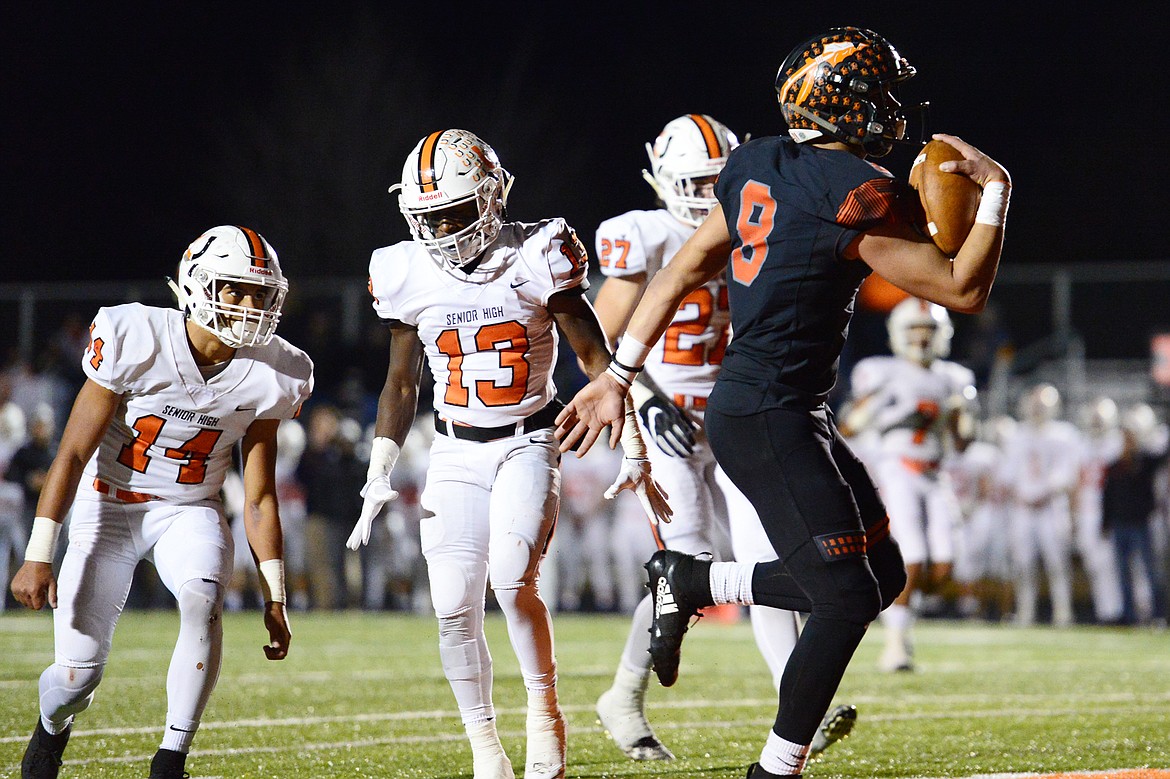 Flathead wide receiver Anthony Jones (8) fights his way into the end zone on a 24-yard touchdown reception in the second quarter against Billings Senior in a Class AA quarterfinal playoff game at Legends Stadium on Friday. (Casey Kreider/Daily Inter Lake)