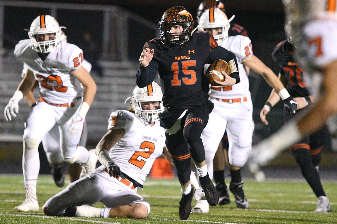 Flathead quarterback Jaden MacNeil (15) breaks free on a 28-yard touchdown run in the first quarter against Billings Senior in a Class AA quarterfinal playoff game at Legends Stadium on Friday. (Casey Kreider/Daily Inter Lake)