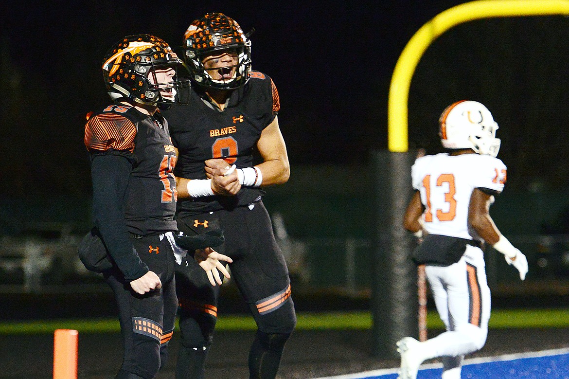 Flathead quarterback Jaden MacNeil (15) celebrates with wide receiver Anthony Jones (8) after a first-quarter touchdown run by MacNeil against Billings Senior in a Class AA quarterfinal playoff game at Legends Stadium on Friday. (Casey Kreider/Daily Inter Lake)