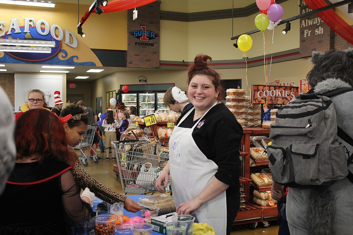 Kassy Lecrenski assisted with the bakery&#146;s cookie decorating table as Super 1 Foods celebrated Halloween.