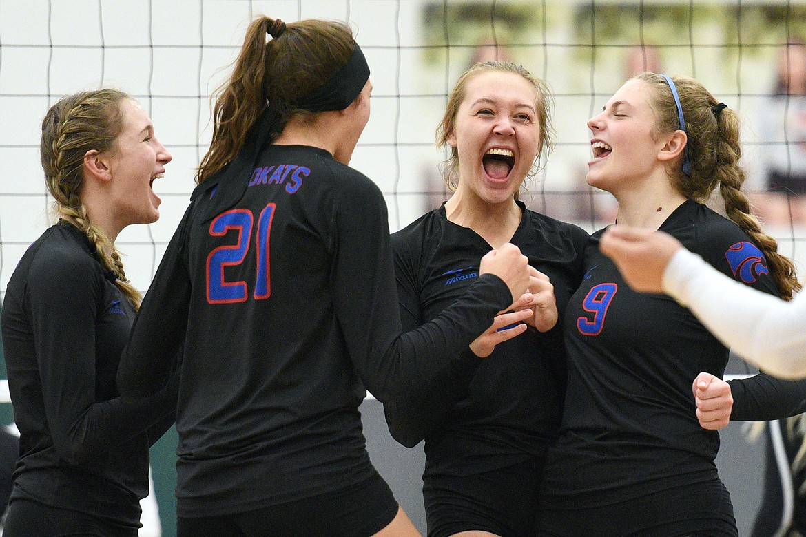 From left, Columbia Falls' Dillen Hoerner (7), Madysen Hoerner (21), Ryley Kehr (23) and Hannah Schweikert (9) celebrate after a point against Stevensville in the Western A Divisional playoffs at Whitefish High School on Thursday. (Casey Kreider/Daily Inter Lake)