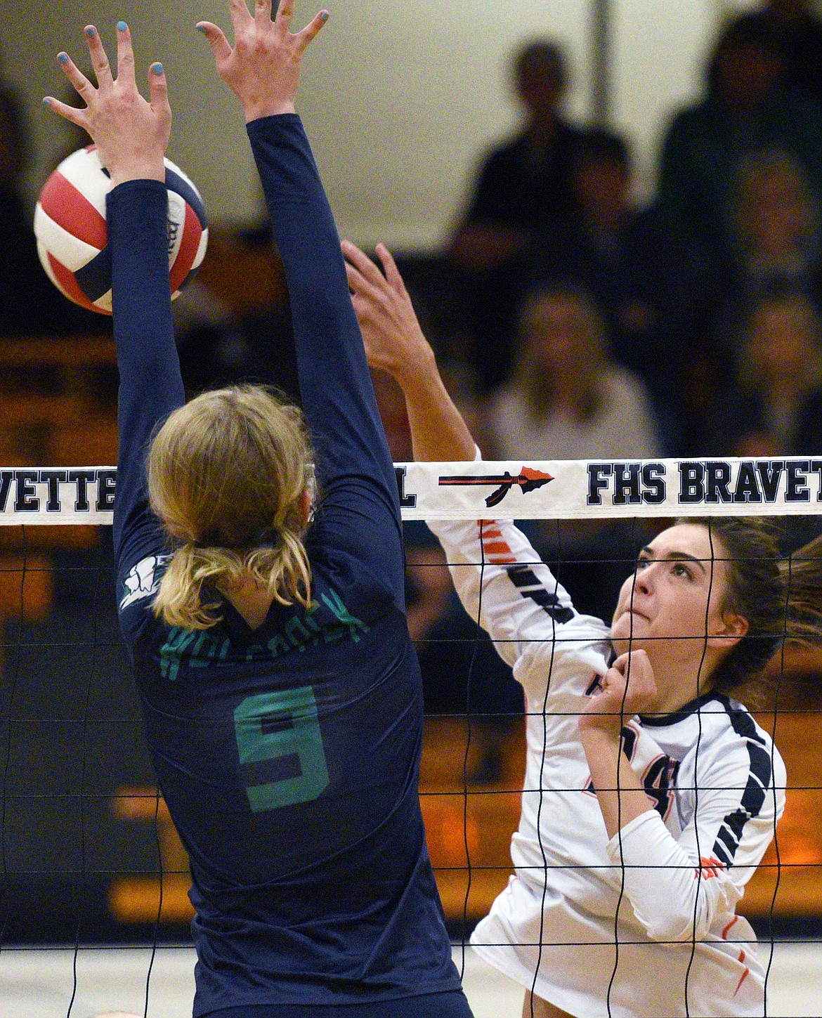 Flathead's Taylor Henley (24) closes out the second match with a kill against Glacier's Kali Gulick (9) during a Western AA playoff at Flathead High School on Thursday. (Casey Kreider/Daily Inter Lake)