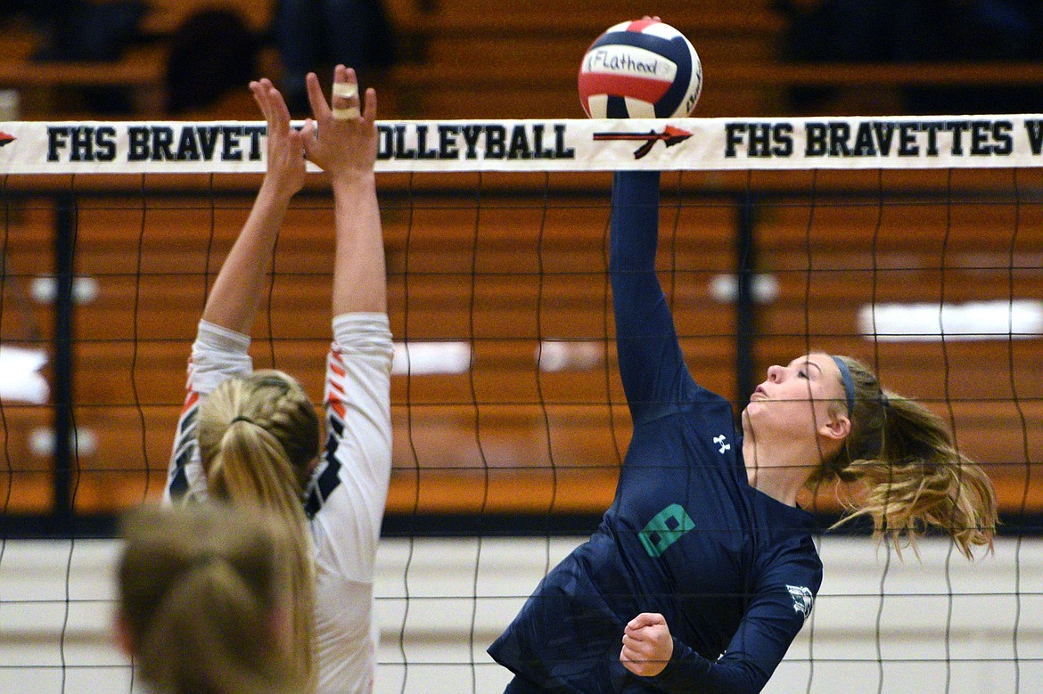 Glacier's Aubrie Rademacher (8) goes up for a kill against Flathead's Jaylyn Fitch (4) during a Western AA playoff at Flathead High School on Thursday. (Casey Kreider/Daily Inter Lake)