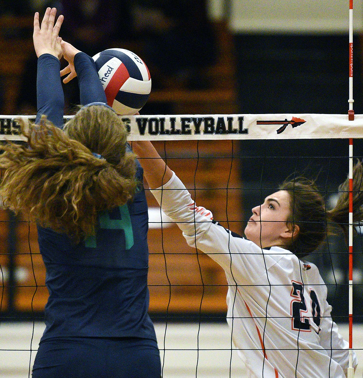 Flathead's Taylor Henley (24) goes for a kill against Glacier's Emma Anderson (14) during a Western AA playoff at Flathead High School on Thursday. (Casey Kreider/Daily Inter Lake)