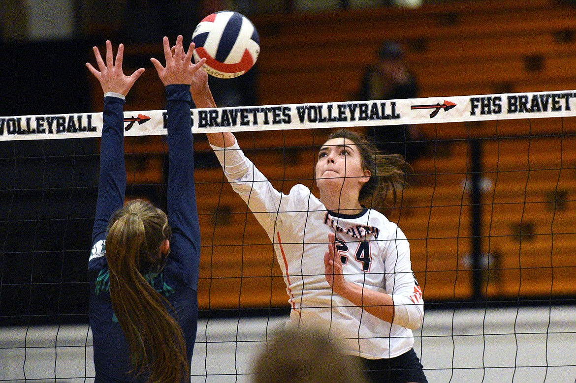 Flathead's Taylor Henley (24) goes up for a kill against Glacier's Bella Waldher (7) during a Western AA playoff at Flathead High School on Thursday. (Casey Kreider/Daily Inter Lake)