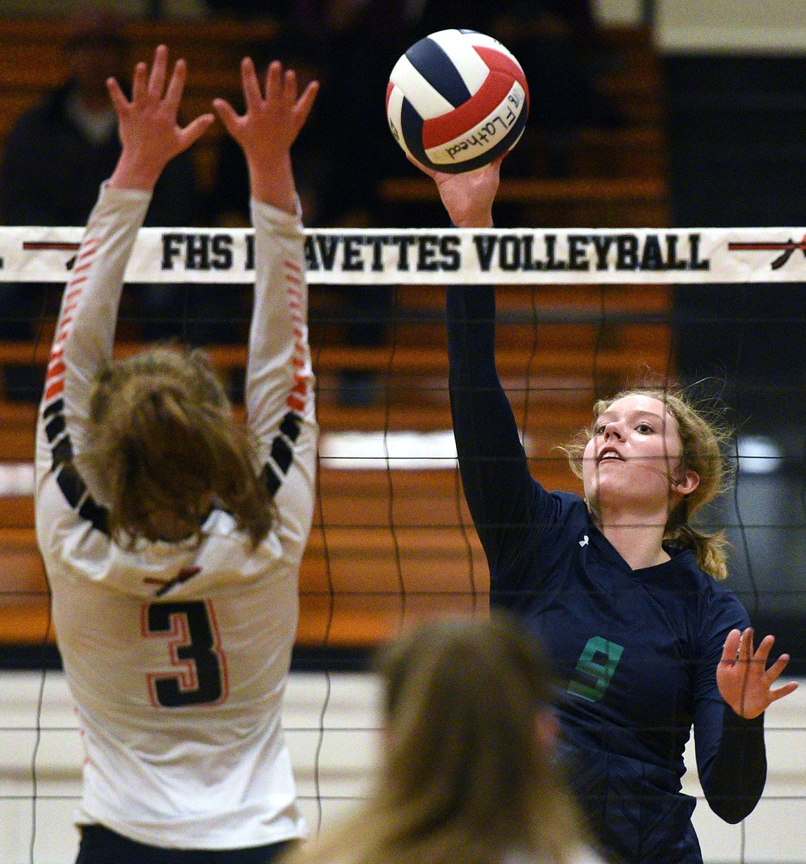 Glacier's Kali Gulick (9) goes up for a kill against Flathead's Sierra Wilhelm (3) during a Western AA playoff at Flathead High School on Thursday. (Casey Kreider/Daily Inter Lake)