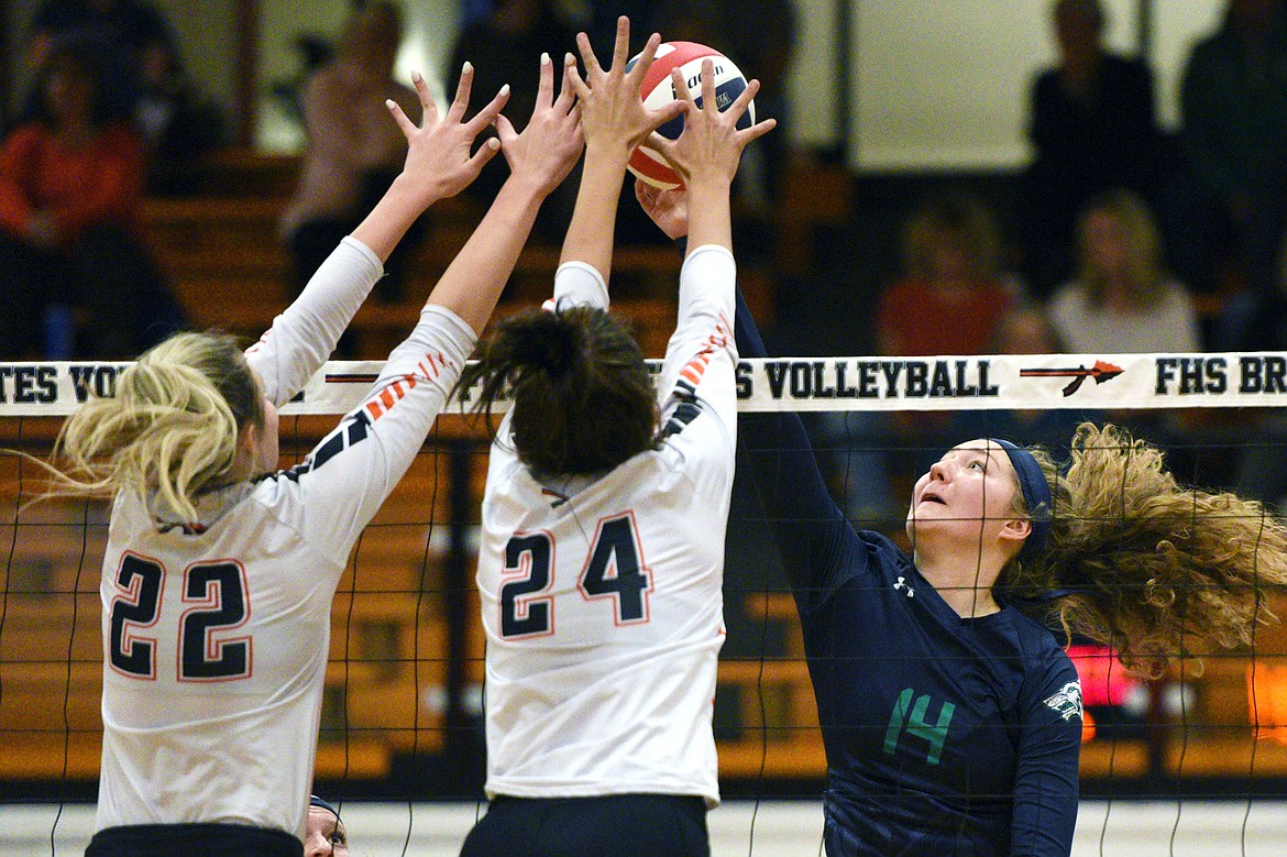 Glacier's Emma Anderson (14) is met at the net by Flathead's Julia Burden (22) and Taylor Henley (24) during a Western AA playoff at Flathead High School on Thursday. (Casey Kreider/Daily Inter Lake)