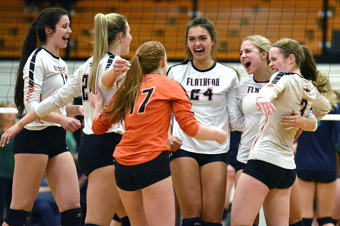 From left, Flathead's Madde Boles (18), Julia Burden (22), Mayson Moore (17), Taylor Henley (24), Jaylyn Fitch (4) and Sierra Wilhelm (3) celebrate after a point against Glacier in the Western AA playoff at Flathead High School on Thursday. (Casey Kreider/Daily Inter Lake)