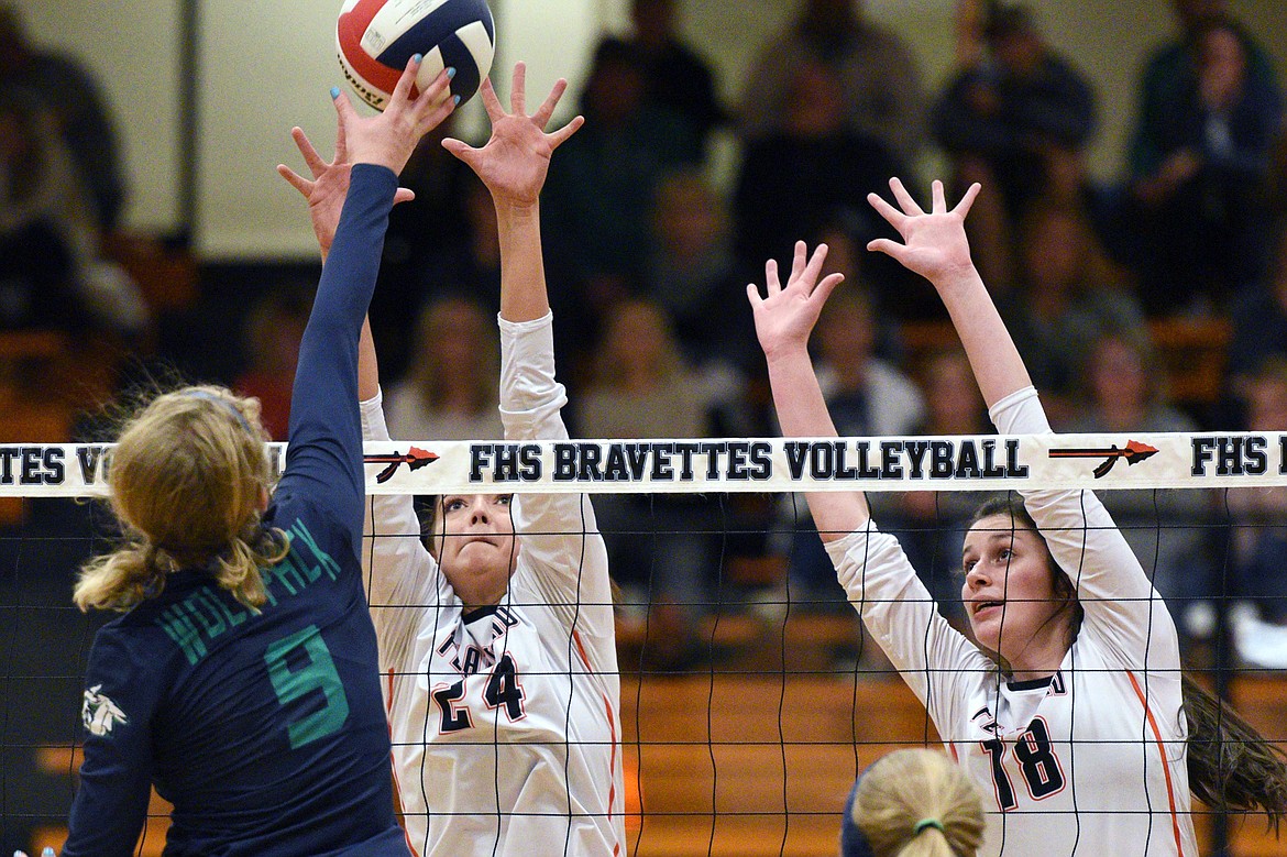 Flathead's Taylor Henley (24) and Madde Boles (18) look for a block against Glacier's Kali Gulick (9) during a Western AA playoff at Flathead High School on Thursday. (Casey Kreider/Daily Inter Lake)