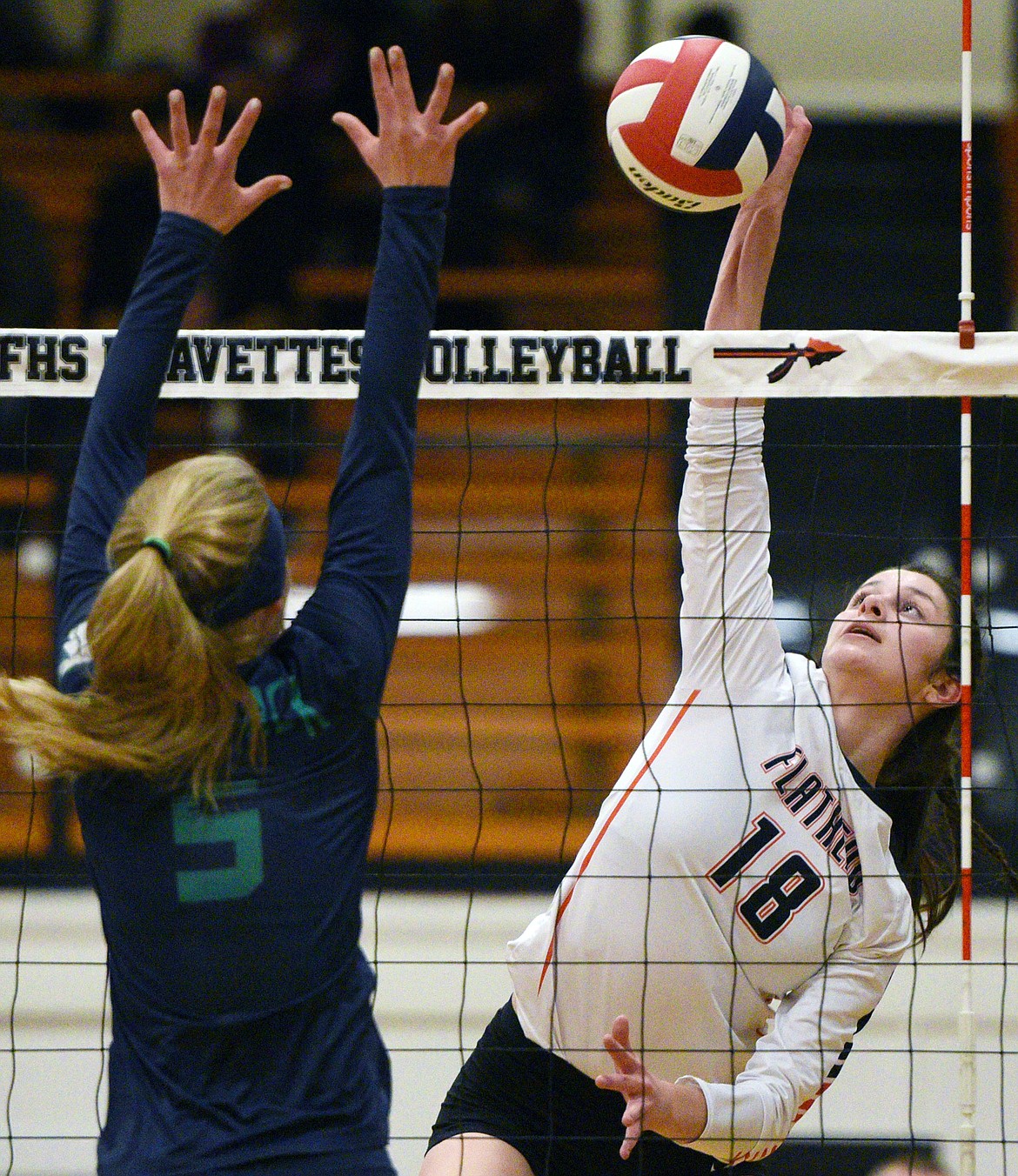 Flathead's Madde Boles (18) goes for a kill against Glacier's Kaylee Fritz (5) during a Western AA playoff at Flathead High School on Thursday. (Casey Kreider/Daily Inter Lake)