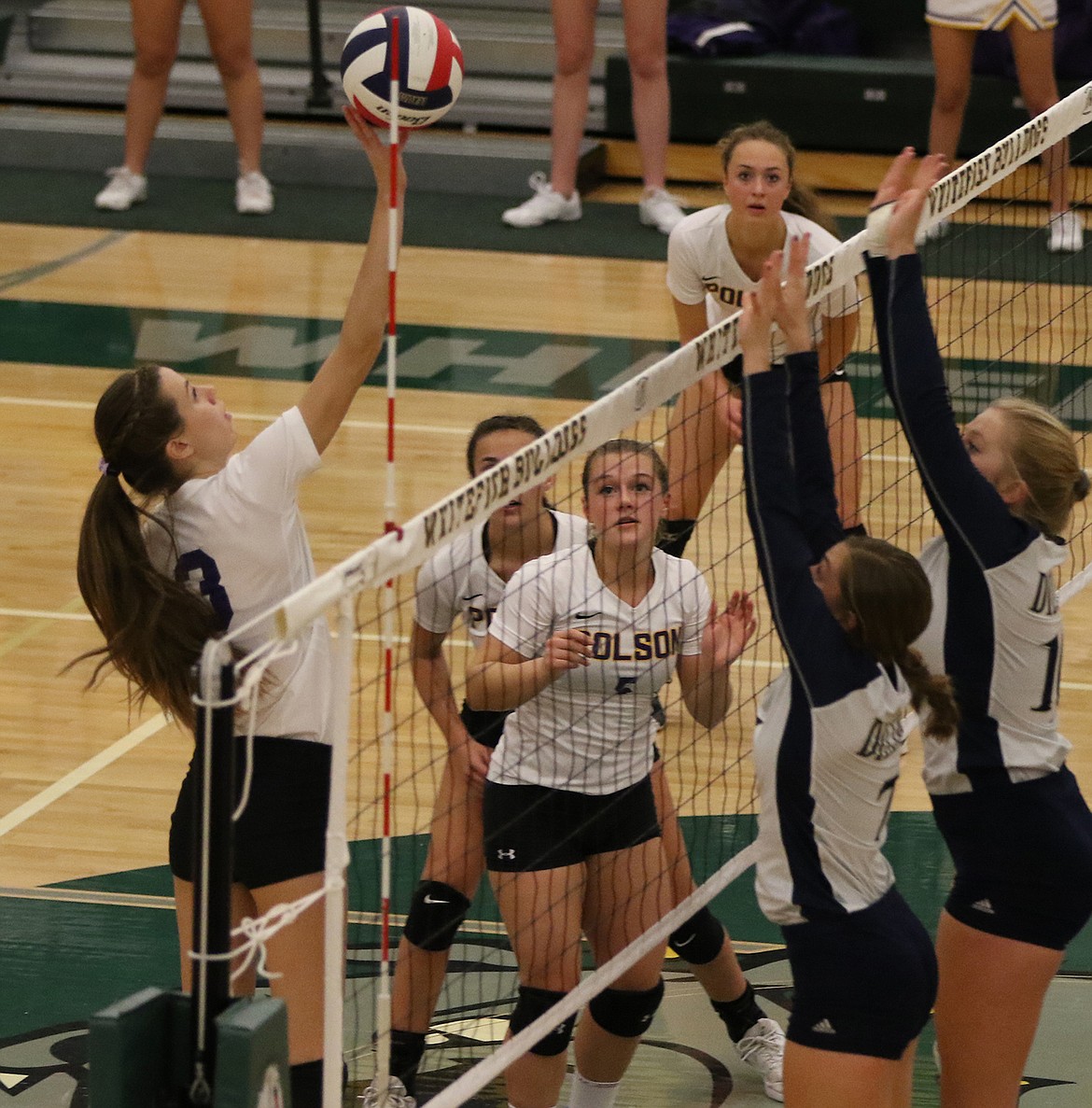 Mikaela DuCharme of Polson tips for a point over Dillon twin blockers.