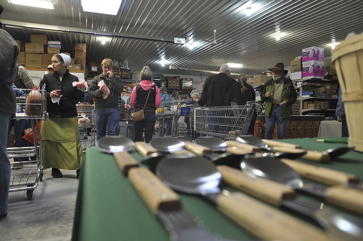 People try some samples offered at the Mission General Store in St. Ignatius. The store gave away ice cream scoopers as a souvenir, commemorating the 15th anniversary of the store.