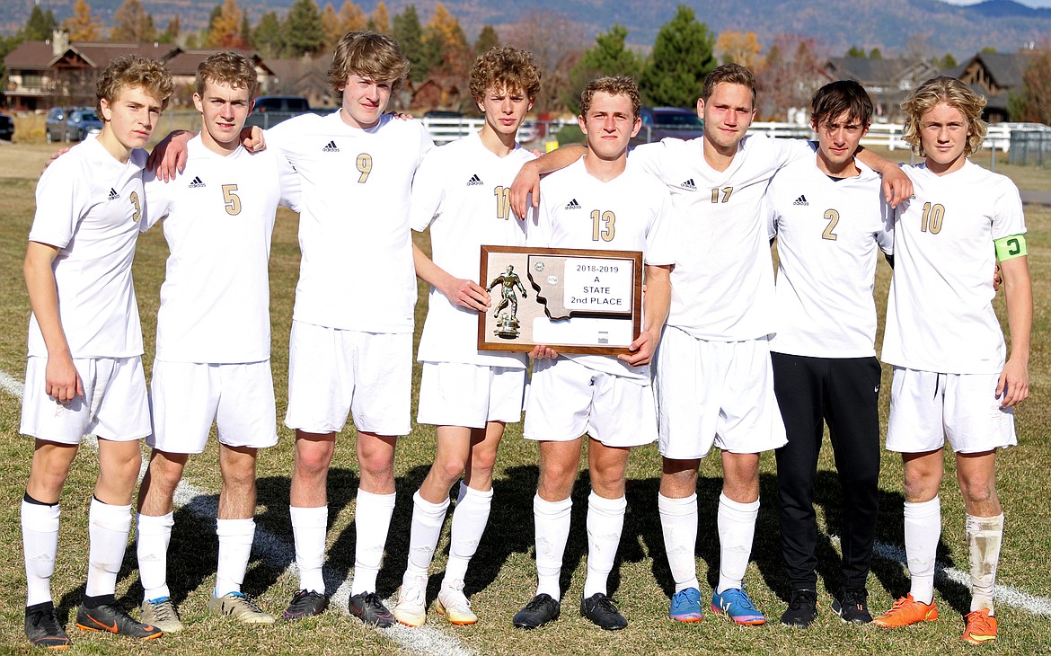 Polson seniors, from left, are Nico River, Keyan Dalbey, Connor Lanier, Robin Erickson, Mack Moderie, Xavier Stalkfleet, Alex Wal-Wilbert and Bridger Wenzel show their runner-up plaque after the Class A state championship match last Saturday in Whitefish. (Bob Gunderson photos/Lake County Leader)