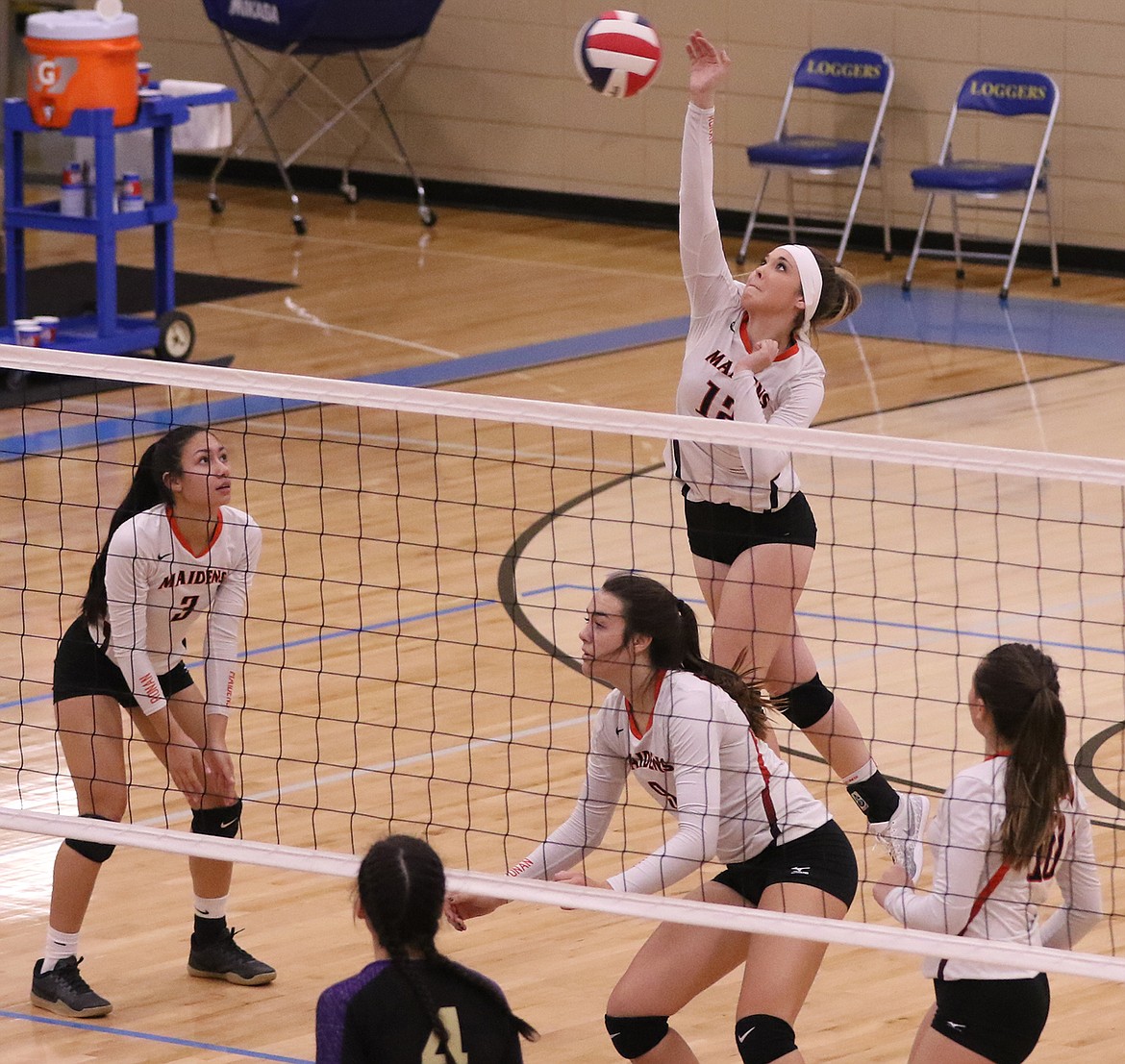 Ronan&#146;s Madison Clairmont drives a back row kill during the Maidens&#146; Northwest A District Tournament match against Polson. Other Ronan players are Tiana Ulutoa (3), Madeline McCrea (9) and Rylie Lindquist (10).  The Polson player is Grace Quinones (3). The Maidens fell in four sets by a 3-1 margin. (Bob Gunderson/Lake County Leader)