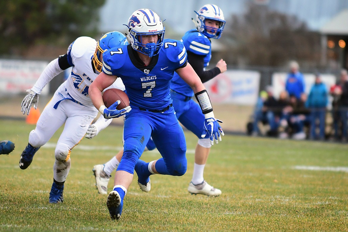 Colten McPhee makes a move before reaching the end zone in the opening quarter Saturday. With his 230 rushing yards against the Eagles, McPhee set the school record for rushing yards in a season with 1,807 and counting. (Jeremy Weber photo)