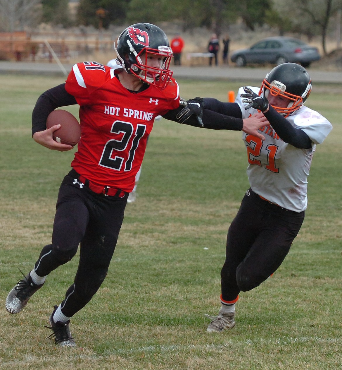 Savage Heat senior Tyler Carr wards off an attempted tackle by Jordan&#146;s Derek Reis during Saturday&#146;s playoff game. (Joe Sova/Clark Fork Valley Press)