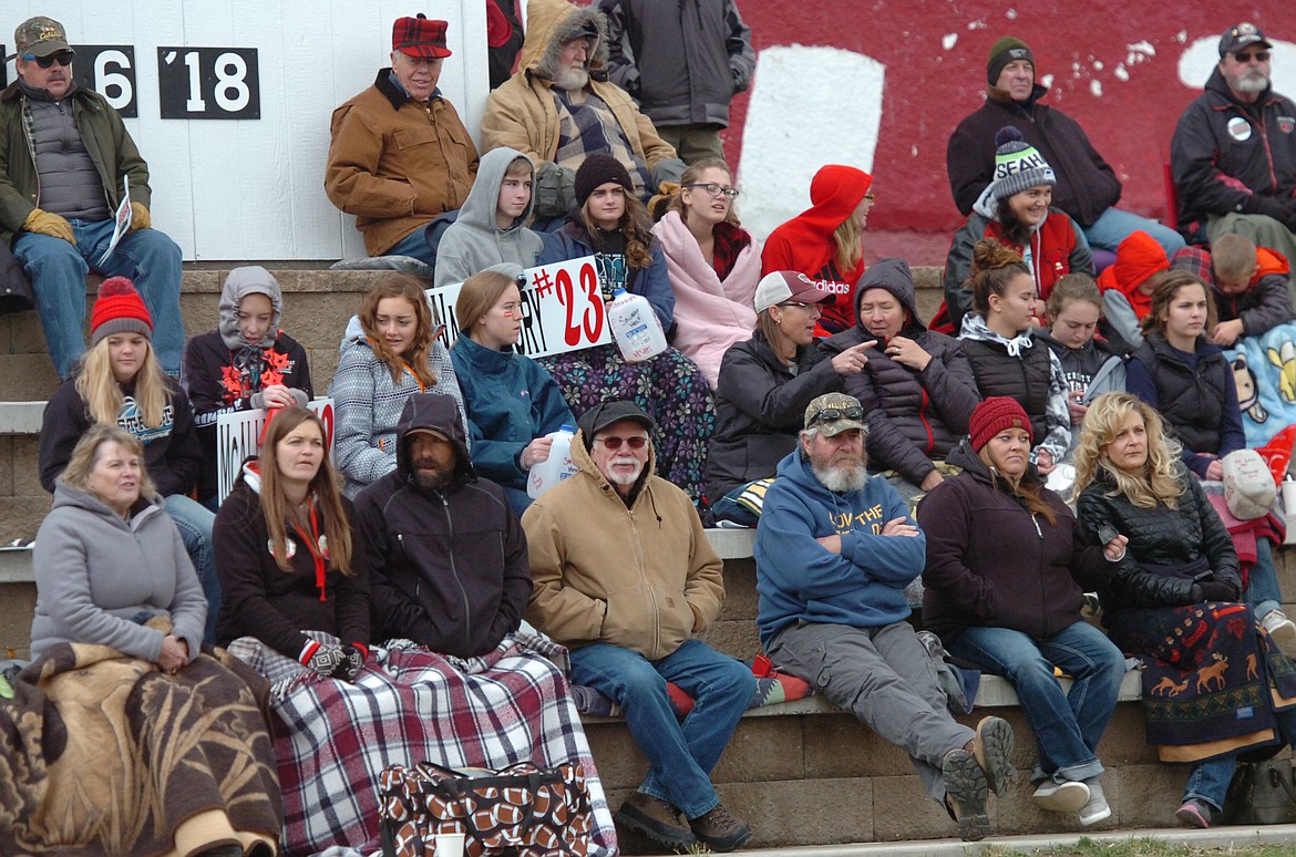 Supporters in the crowd are bundled up on a cool, windy Saturday afternoon to watch the Savage Heat take on Jordan in a state playoff quarterfinal game. The Mustangs were not to be tamed, winning 74-57. (Joe Sova/Clark Fork Valley Press)