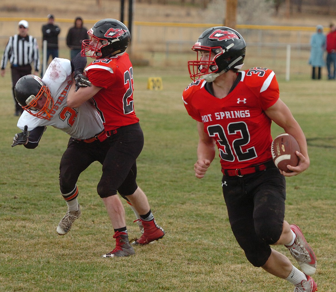 Savage Heat senior Tyler Knudsen gets a great block from Luke Waterbury en route to a big gain last Saturday against Jordan in the second round of the Class C 6-man State Playoffs. The Mustangs outscored Hot Springs, 74-57. (Joe Sova/Clark Fork Valley Press)