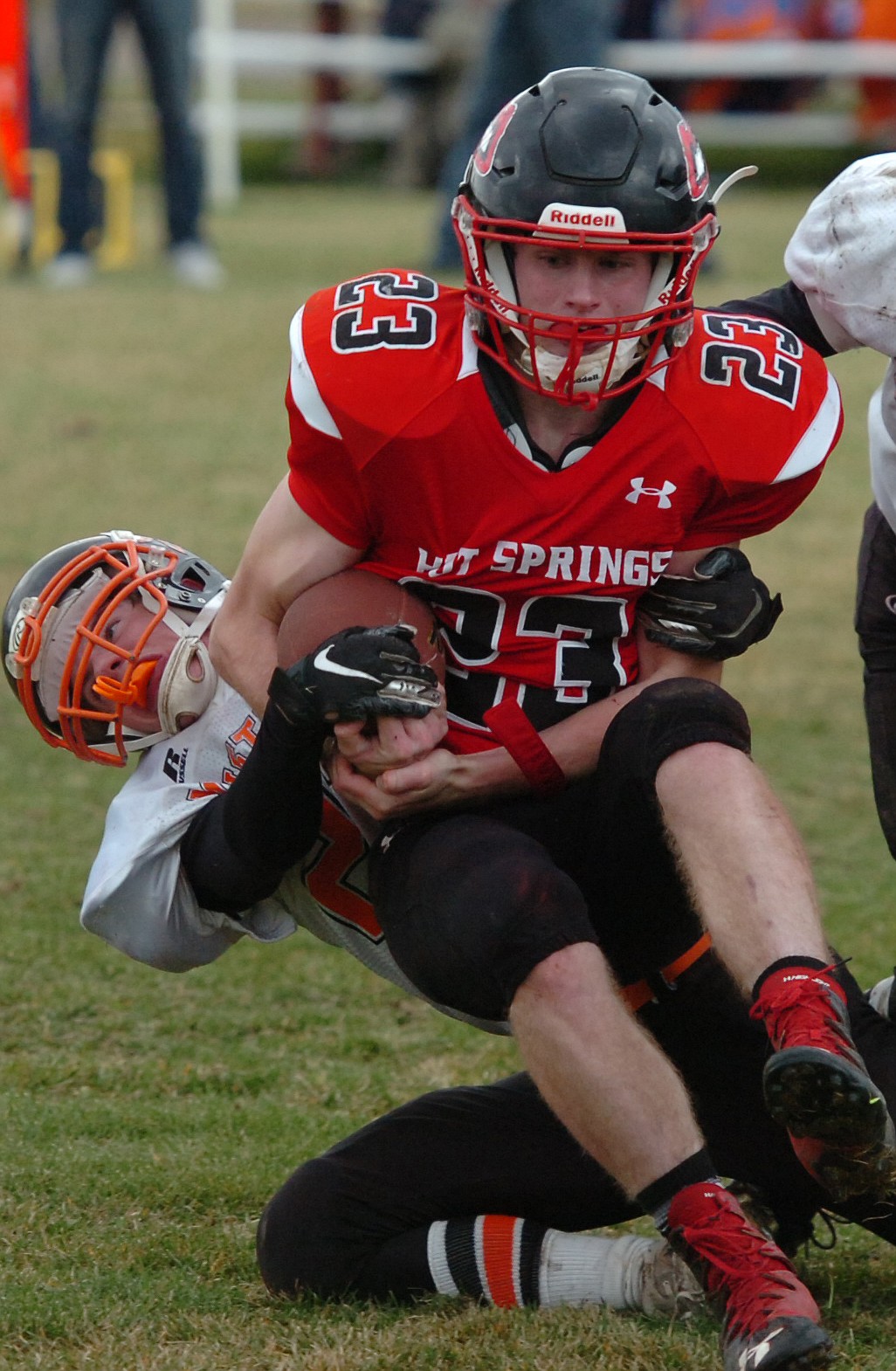 Hot Springs junior Luke Waterbury holds onto the football while being tackled by a Jordan defender during Saturday&#146;s state playoff contest. (Joe Sova/Clark Fork Valley Press)