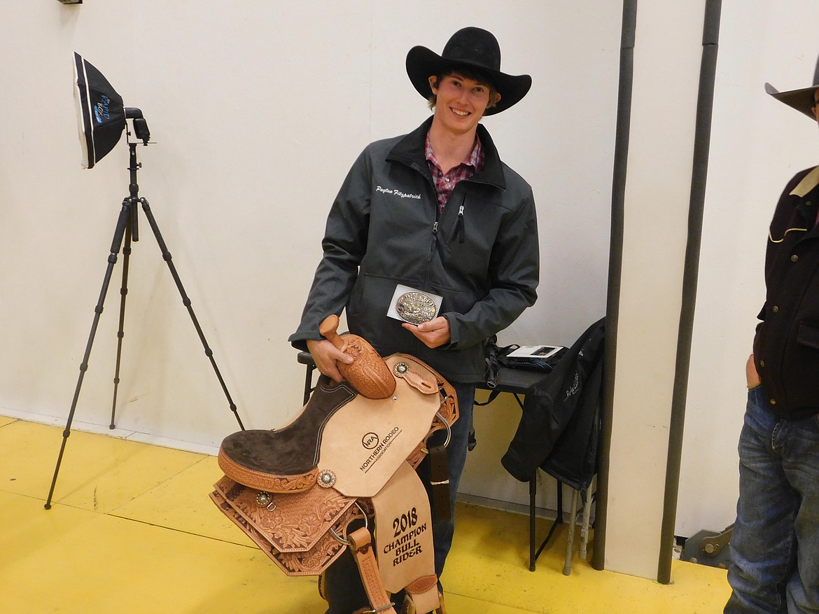 Payton Fitzpatrick holds the saddle he won for taking the Northern Rodeo Association bull riding championship. (Photo courtesy of Elisha Fitzpatrick)