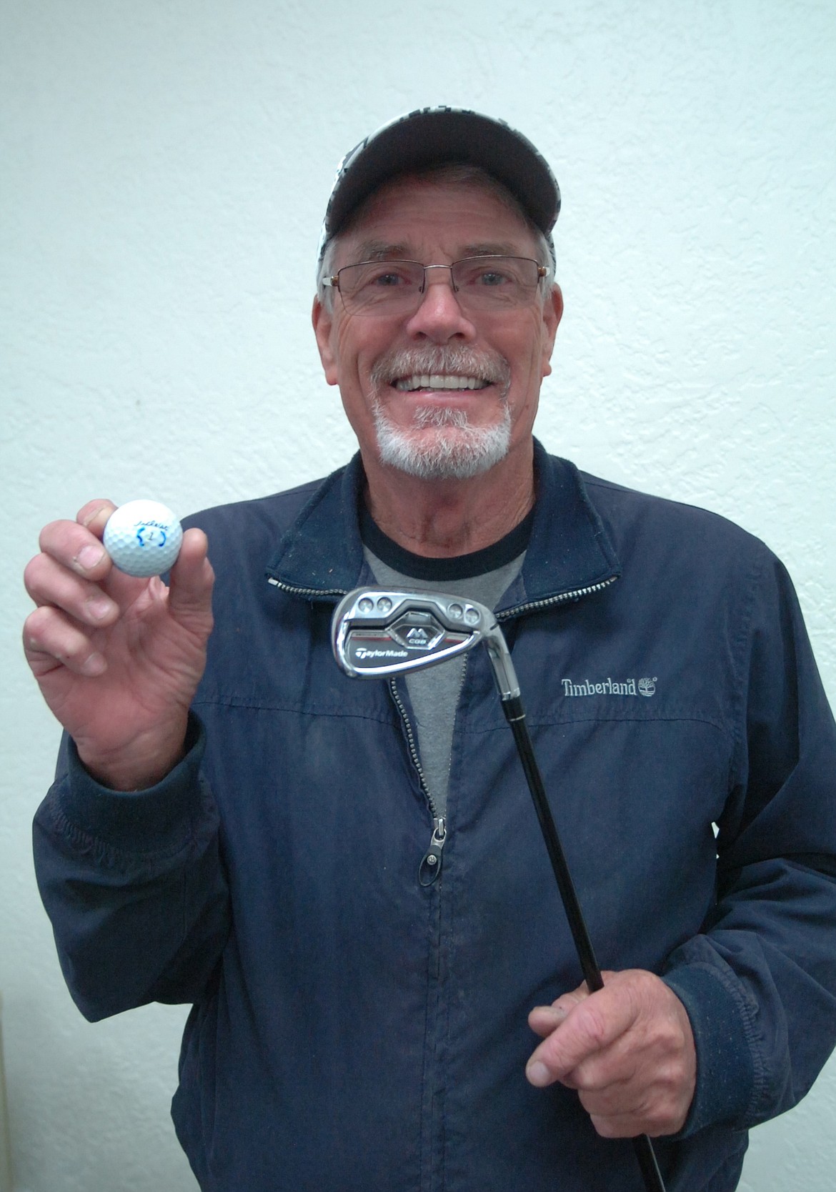 Burt Cannon of Ronan shows the 8-iron and Titleist ball he used for a hole-in-on on No. 9 at the Polson Golf Course last Thursday, Oct. 25. It was the sixth ace during his amateur career. (Joe Sova/Lake County Leader)