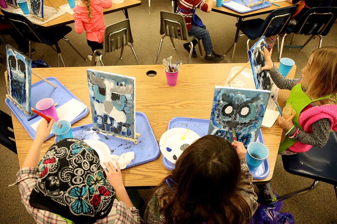 Students draw owls during an after school program at Athol Elementary on Wednesday. (LOREN BENOIT/Press)