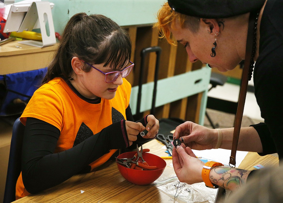 Athol Elementary School music teacher Sarah Windish helps fifth-grade student Kadia Anast with a science project after school on Wednesday. (LOREN BENOIT/Press)