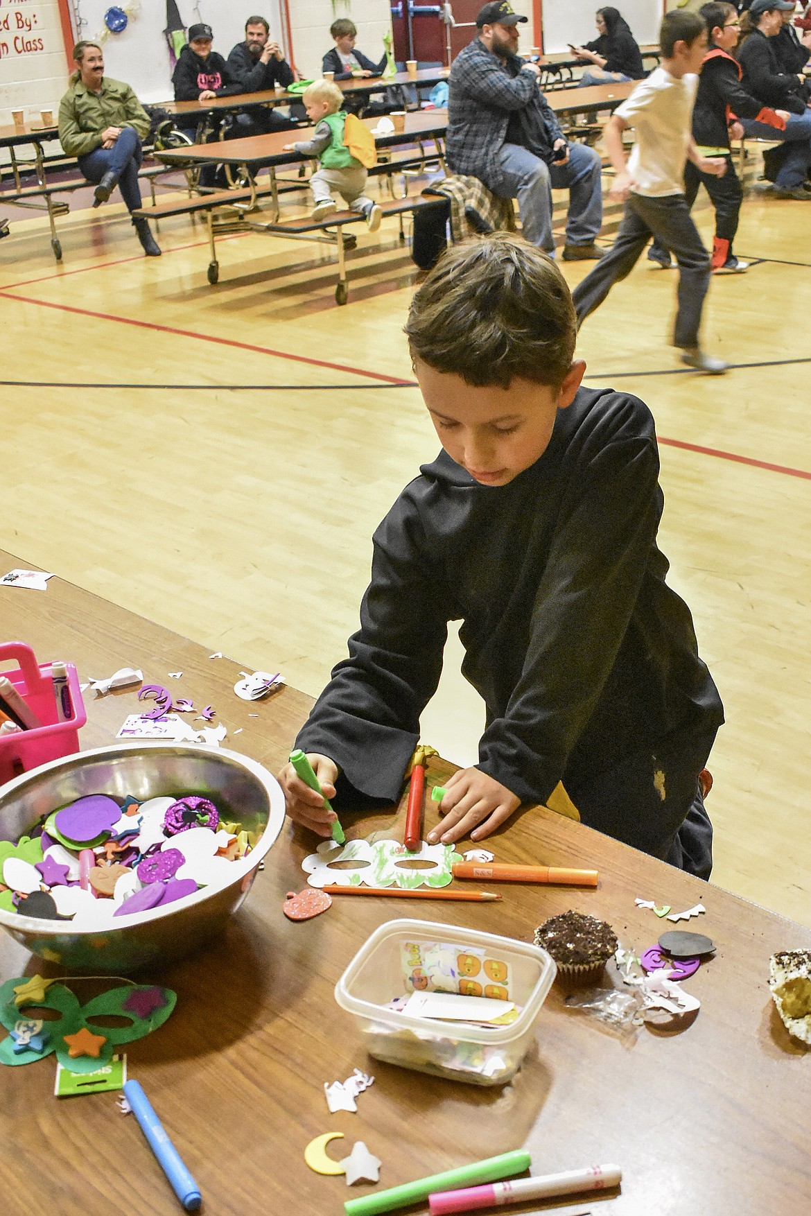 Bowyn Melcher works on a mask at Troy&#146;s W.F. Morrison Elementary during the After School Program Halloween Carnival Wednesday, a part of the ASP&#146;s Lights On After School programs. (Ben Kibbey/The Western News)