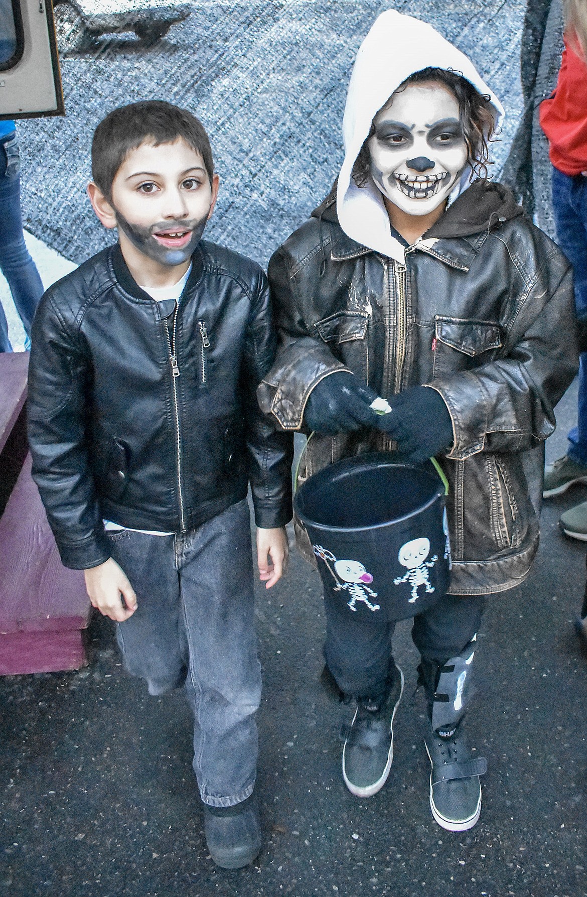 Henry Roy as Negan from The Walking Dead, and Preston Stafford as a Fortnite &#147;Skull Trooper&#148; exit the haunted school bus all smiles at Trunk-or-Treat at the Troy Activity Center Wednesday. (Ben Kibbey/The Western News)