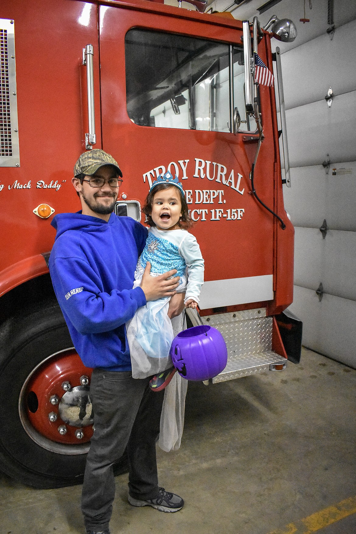 Troy Volunteer Fire Department firefighter Trevor Cratty and his princess Katelynn pose as Katelynn hollers &#147;fire truck&#148; during the Halloween open house at the Troy Volunteer Fire Department Wednesday (Ben Kibbey/The Western News)