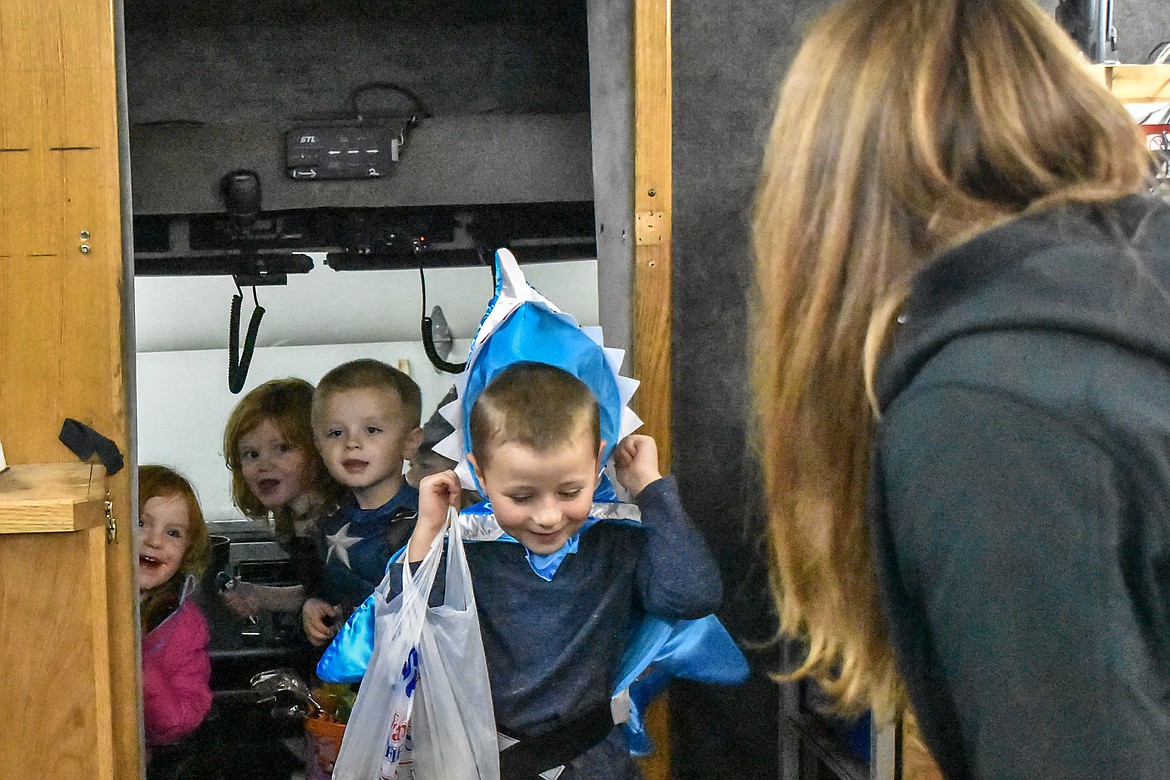 &#147;Mom, we&#146;re driving a fire truck!&#148; Vera Towery called out to Andrea Towery while getting a tour of the fire van along with Audrey Towery and Thomas and Ryan Wells during the Halloween open house at the Troy Volunteer Fire Department Wednesday (Ben Kibbey/The Western News)