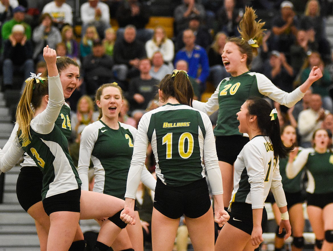 The Lady Dogs celebrate a point against Stevensville in the Western A Divisional Tournament last week at Whitefish High School. (Daniel McKay/Whitefish Pilot)