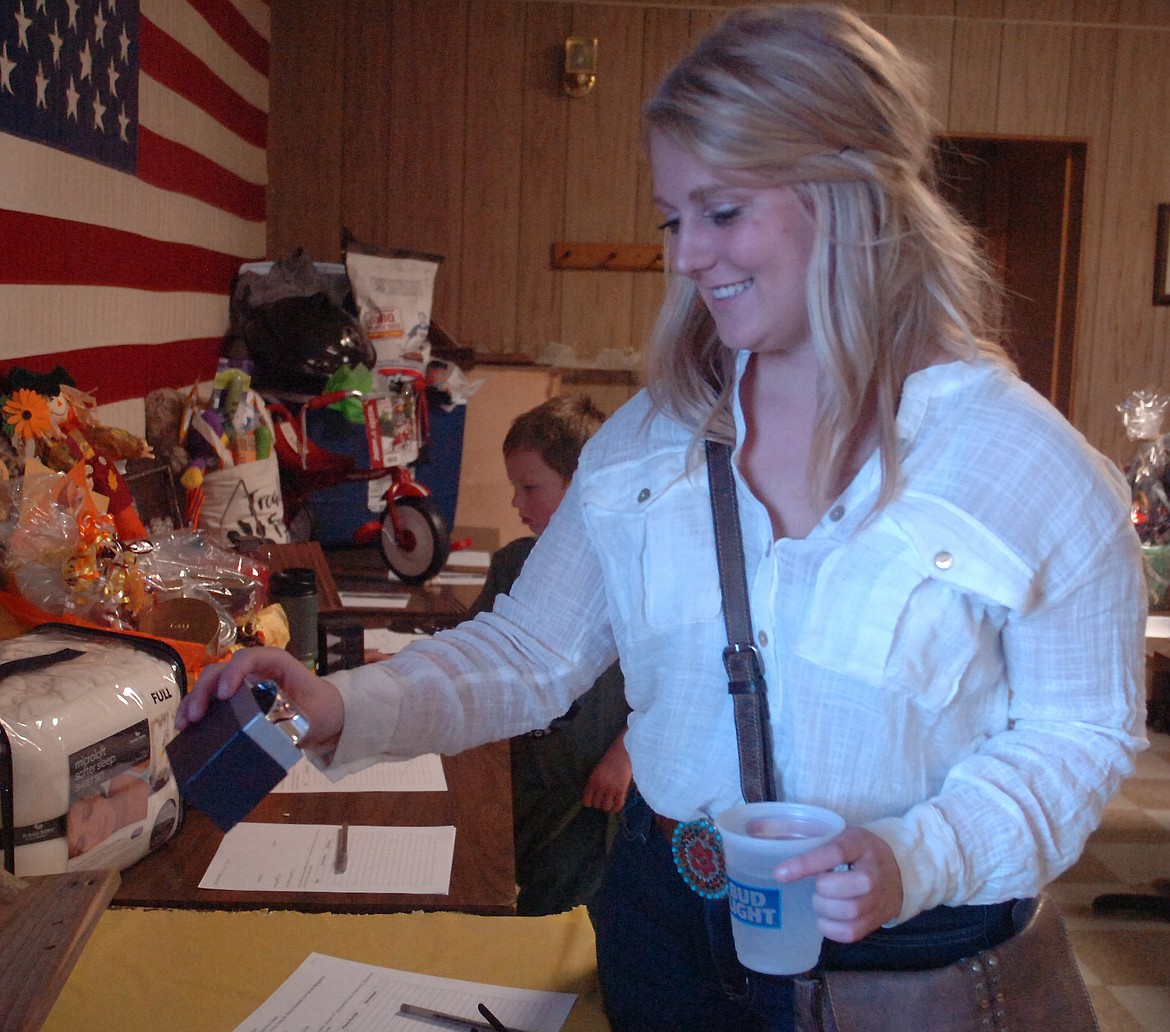 Mary Hillerman takes a close look at a beautiful bracelet from among the myriad of silent auction items available during the Cole Goodwin benefit last Saturday night