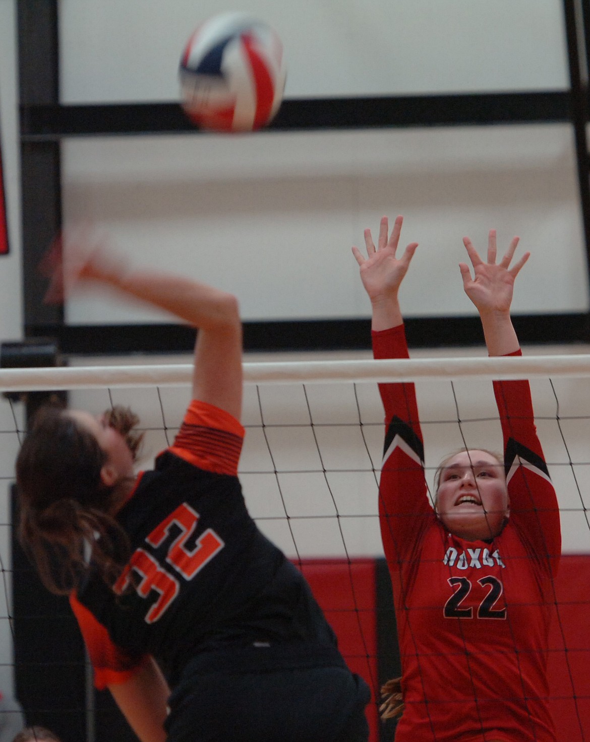 Noxon senior Delaney Weltz rises to attempt a block on an attack by Plains junior Kylee Altmiller during their first-round match in the District 14C Volleyball Tournament at Hot Springs High School. Plains squeaked out a five-set win before upsetting previously unbeaten Charlo in the quarterfinals. (Joe Sova/Clark Fork Valley Press)