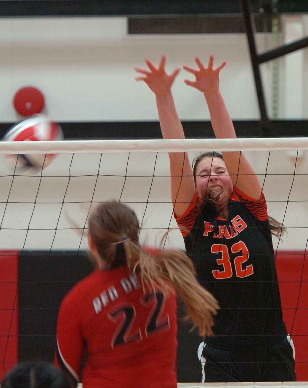 Kylee Altmiller of Plains rises to attempt a block of an attack by Noxon&#146;s Delaney Weltz during first-round action last Thursday in the District 14C Tournament in Hot Springs. Plains defeated Charlo 3-2 to capture the tourney title. (Joe Sova/Clark Fork Valley Press)