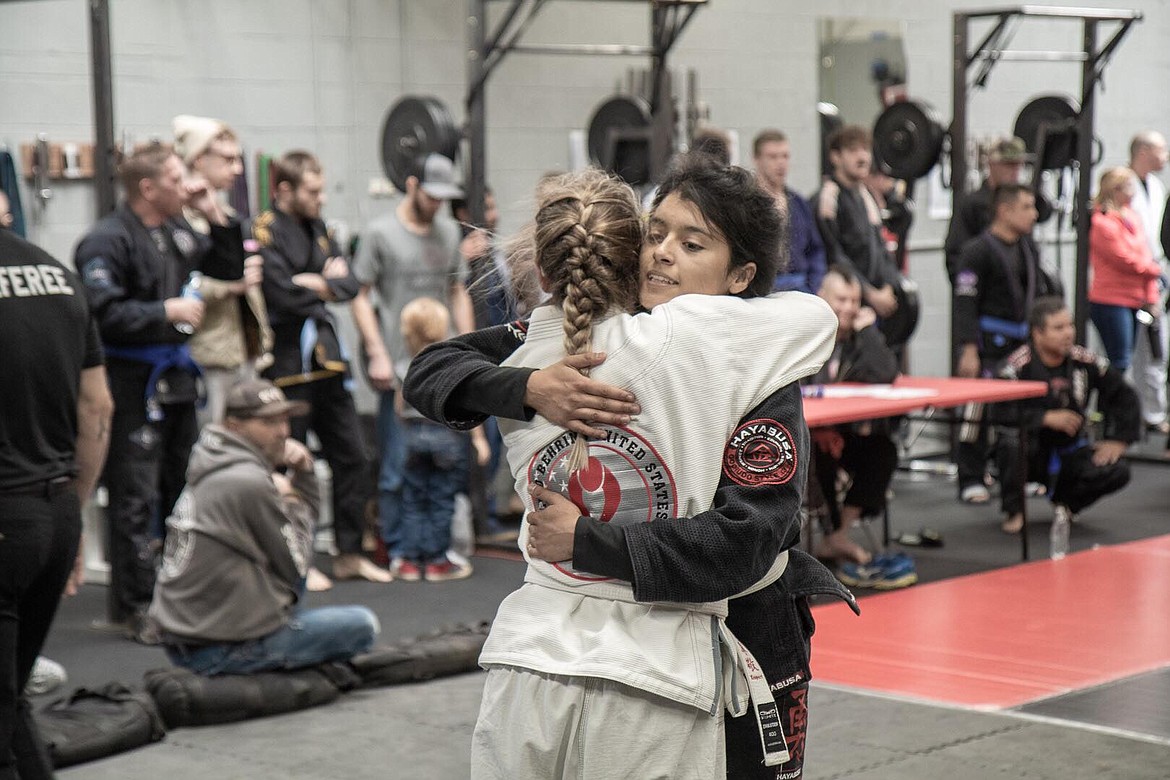 Marrisa Rink (left) hugs her opponent after a hard-fought match.