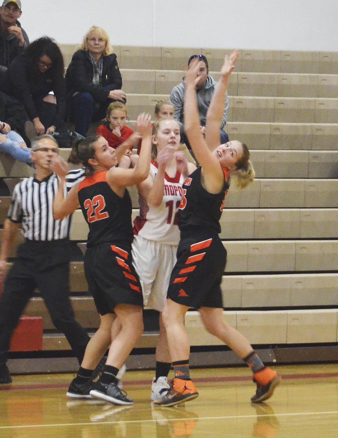 KYLE CAJERO/Bonner County Daily Bee
Post Falls defenders Kennedy LaFountaine, left, and Ali Carpenter trap Sandpoint&#146;s Brooklen Steiger along the baseline on Saturday.