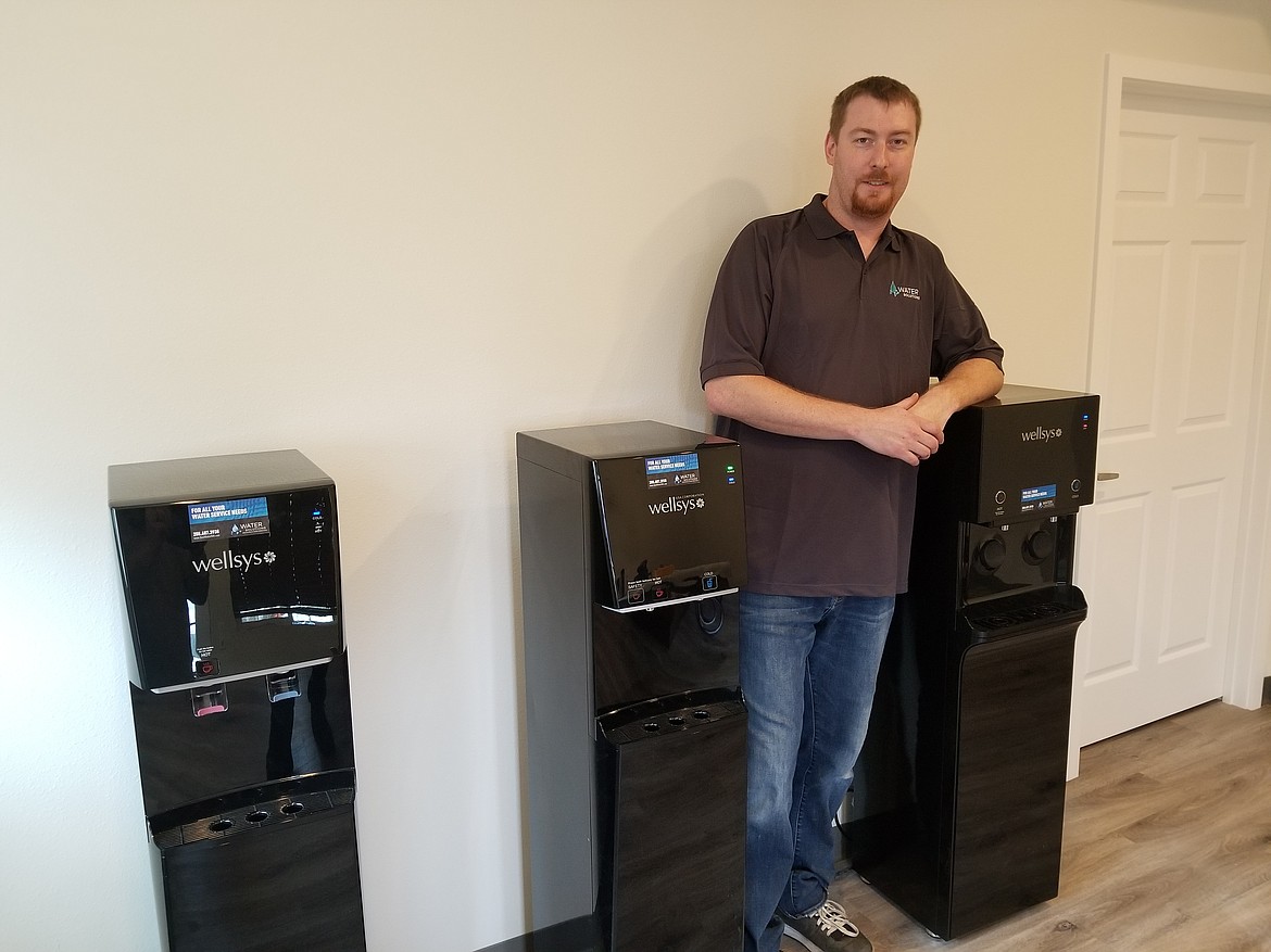 Water Solutions has expanded and moved to 14655 Kimo Court in Rathdrum. Service technician Aaron Ward stands with several of the company&#146;s drinking water systems.