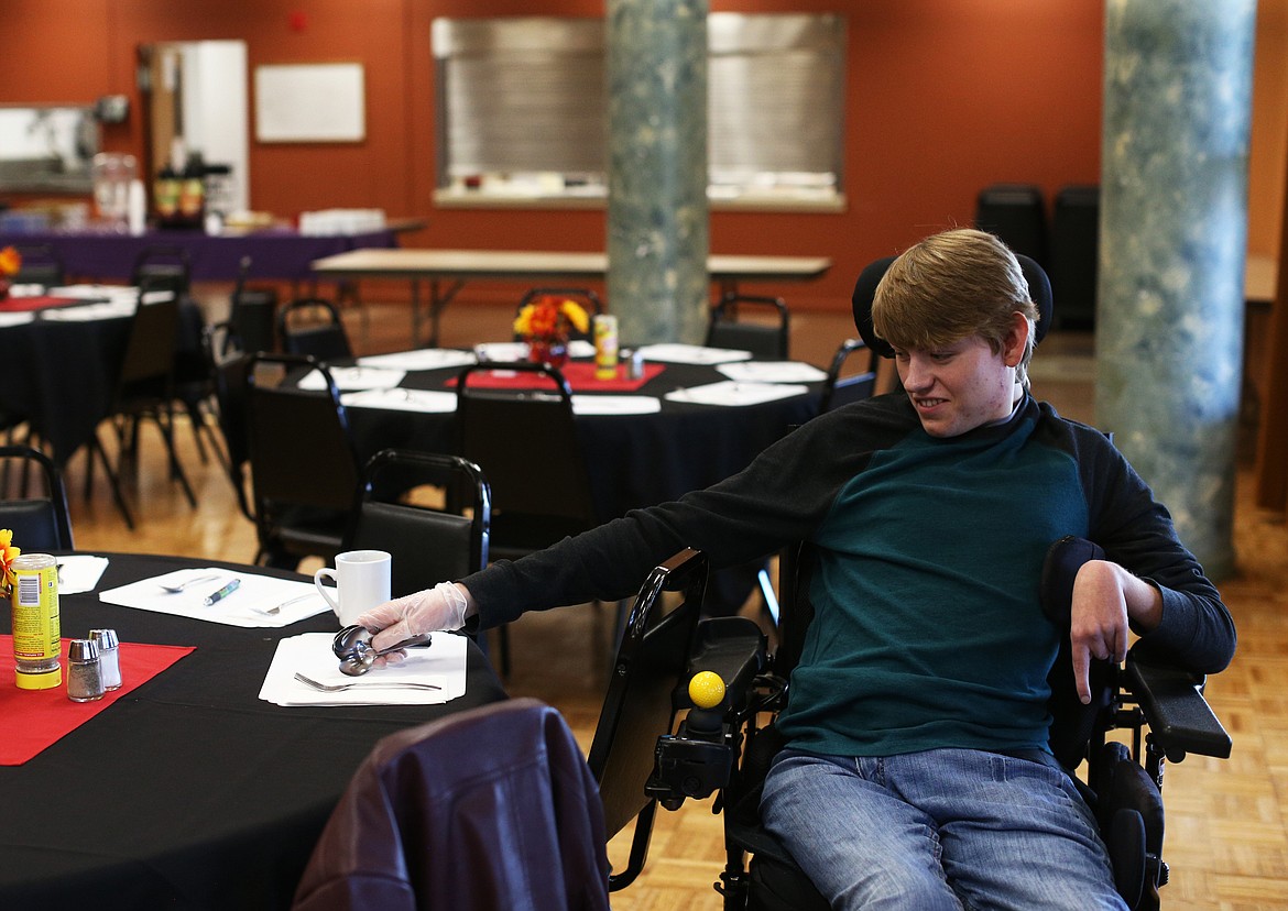 LOREN BENOIT/Press
Aaron Findlay, 20, of Hayden, volunteers his time every Monday and Friday to set up tables for Lake City Center&#146;s lunch service. He was born with half a heart and suffered a stroke as a baby during surgery, which confined him to a wheelchair, but despite everything he is determined to give back to his community.