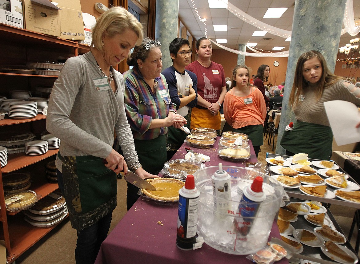 Sally Ellingsen of Coeur d&#146;Alene slices into a pumpkin pie last year during the 20th annual Lake City Center Free Thanksgiving Day Meal. Several locations in Post Falls and Coeur d&#146;Alene will provide free meals to the community in the days leading up to Thanksgiving. Lake City Center and Freedom Burrito in Post Falls will host their free meals on the actual holiday. (DEVIN WEEKS/Press file)