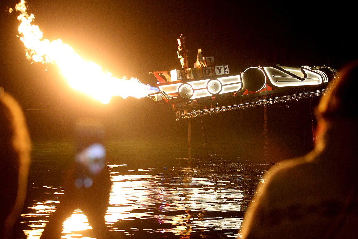 Guests watch flames shoot out the back of Santa&#146;s Sleigh during a Journey to the North Pole Cruise Thursday night.