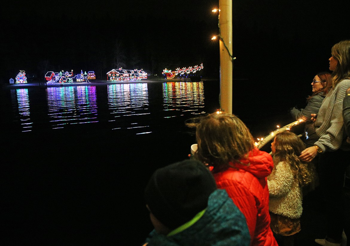 Guests scan the shoreline of the North Pole after the lights of Santa&#146;s workshop illuminated the landscape during the Journey to the North Pole cruise Thursday night. (LOREN BENOIT/Press)