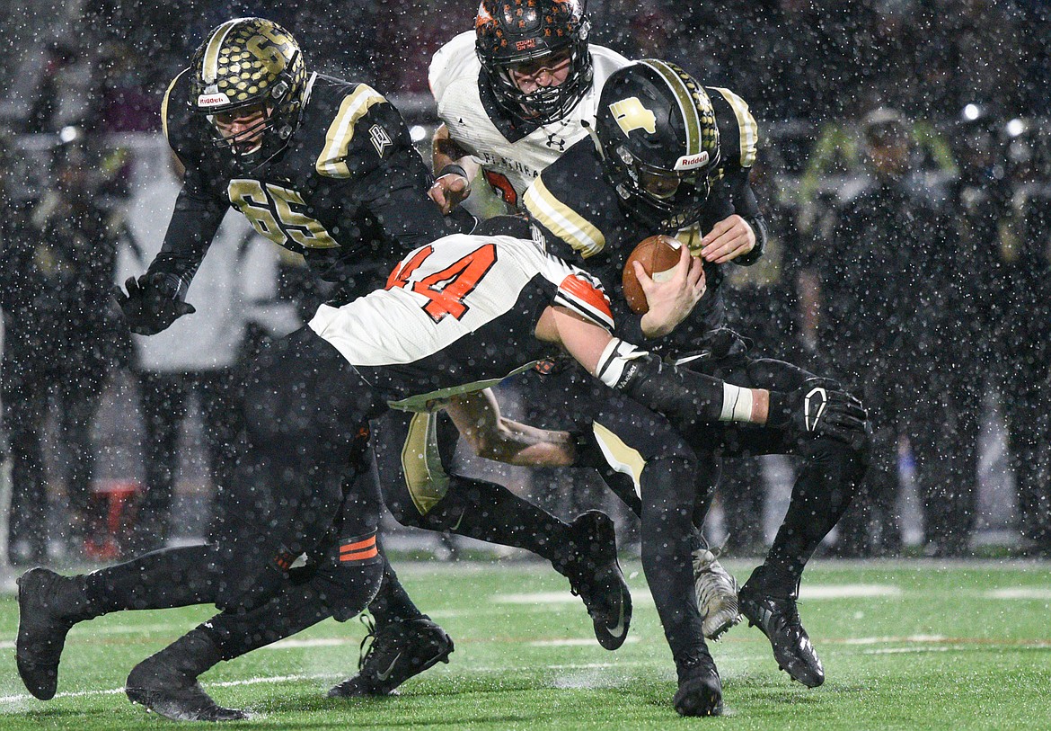 Flathead linebacker Tanner Russell (44) sacks Billings West quarterback Josh Erbacher (1)  in the third quarter of the Class AA state championship at Wendy&#146;s Field at Daylis Stadium in Billings on Friday. (Casey Kreider/Daily Inter Lake)