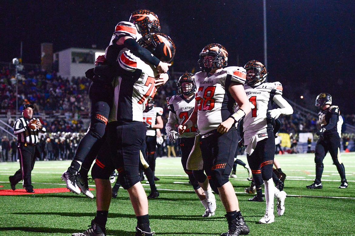 Flathead quarterback Jaden MacNeil (15) celebrates with teammates after a first-half touchdown run againstbb Billings West in the Class AA state championship at Wendy&#146;s Field at Daylis Stadium in Billings on Friday. (Casey Kreider/Daily Inter Lake)