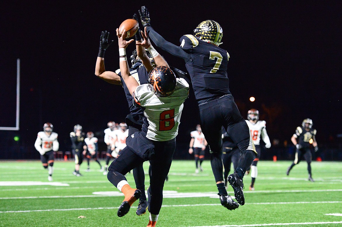 Billings West defensive backs Jesse Owens (3, back) and Lucas Gibb (7) break up a pas intended for Flathead wide receiver Anthony Jones (8) in the Class AA state championship at Wendy&#146;s Field at Daylis Stadium in Billings on Friday. (Casey Kreider/Daily Inter Lake)